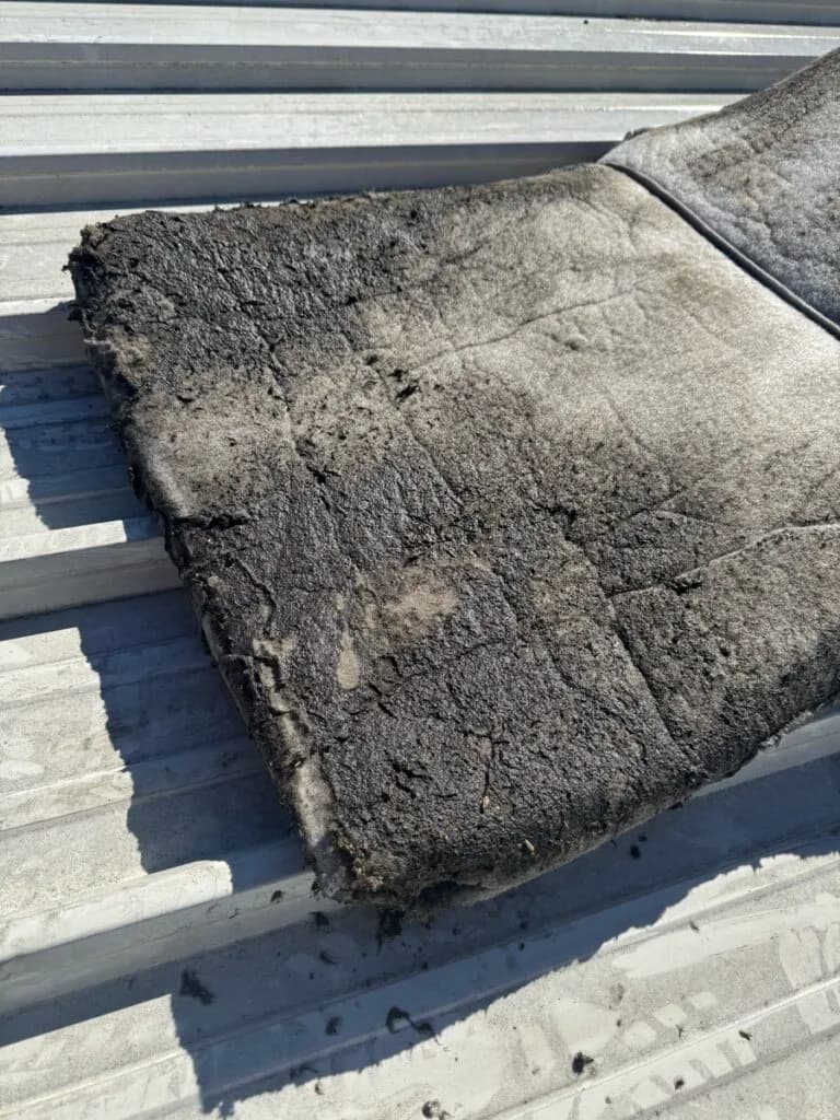 HVAC bag filter covered in thick dirt